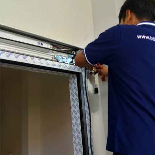 Bfloor Expertise team member installing an automatic door system.
