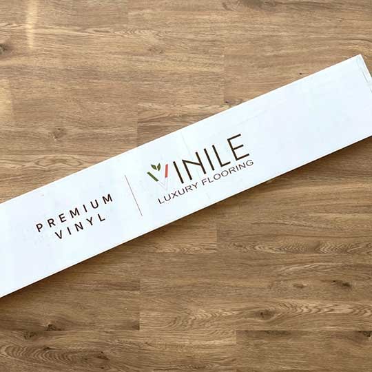 Vinile product box displayed on Vinile flooring, showcasing premium quality.