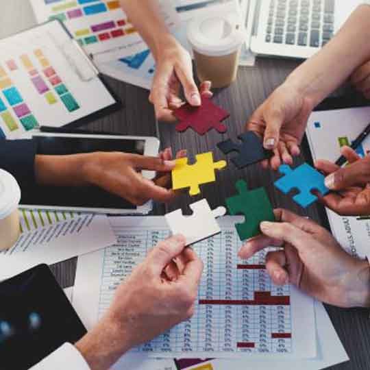 Multiple hands coming together symbolizing teamwork and a collaborative spirit